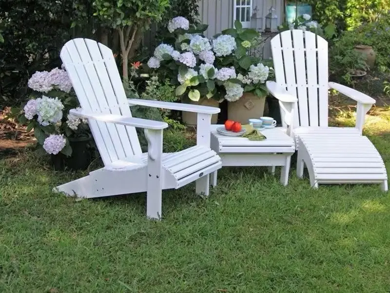 White HDPE classic Adirondack chair and lounge set on green garden lawn for park public seating