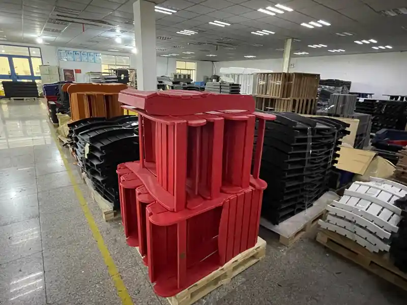 Stacked red HDPE Adirondack chairs in warehouse showcasing bulk inventory for B2B wholesale buyers