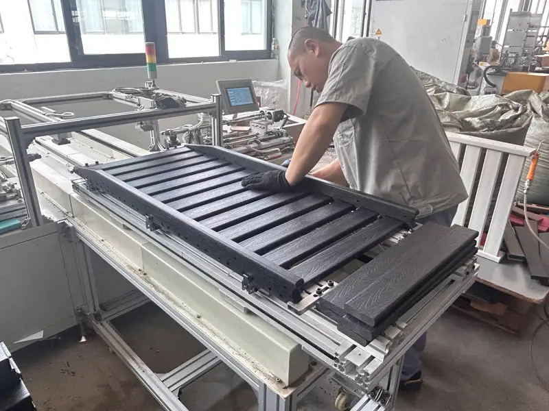 Factory worker assembling HDPE chaise lounge parts during bulk manufacturing