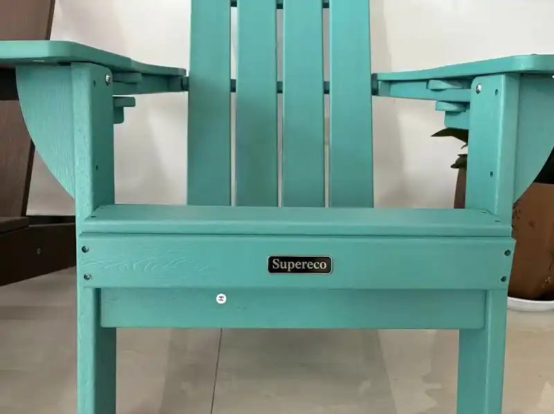 Teal HDPE Adirondack chair front view showcasing custom metal logo badge for private label branding
