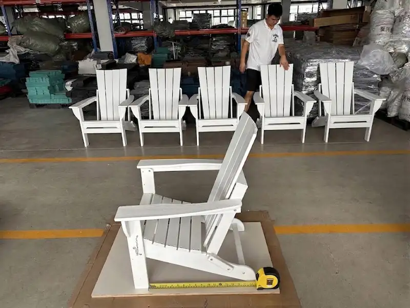 White HDPE Adirondack chair being measured with tape measure for quality inspection