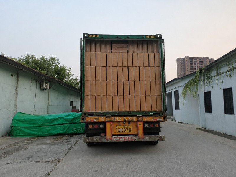 Freight truck being loaded with packaged HDPE outdoor chairs at poly lumber garden furniture factory