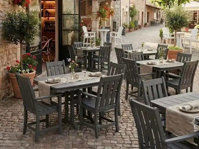Dark grey poly lumber outdoor dining tables and chairs in café patio