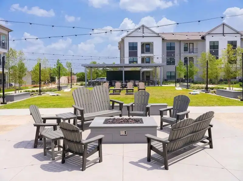 Grey HDPE outdoor benches and Adirondack Chairs in a landscaped public park area